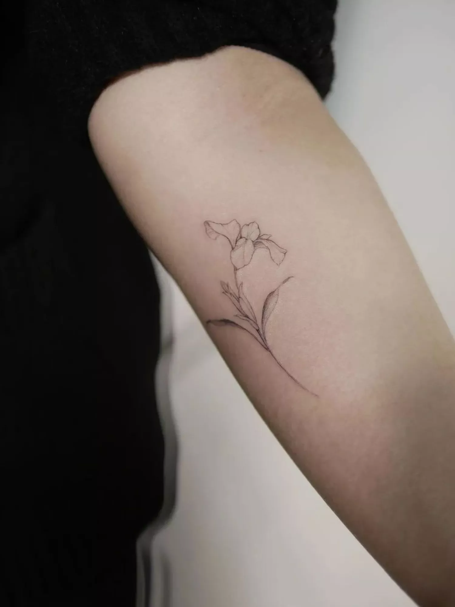 forearm with flower tattoo