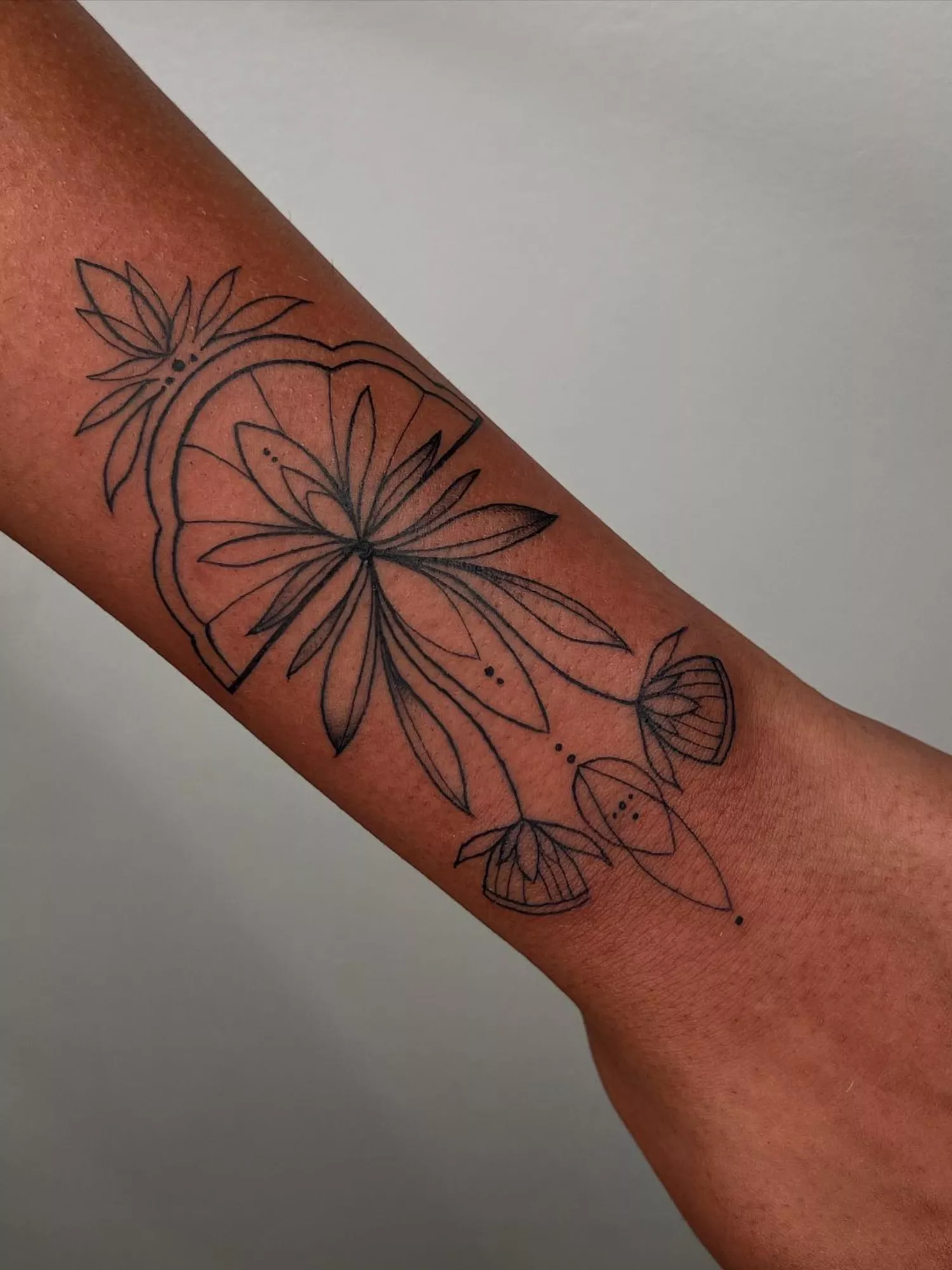 forearm with flower tattoo