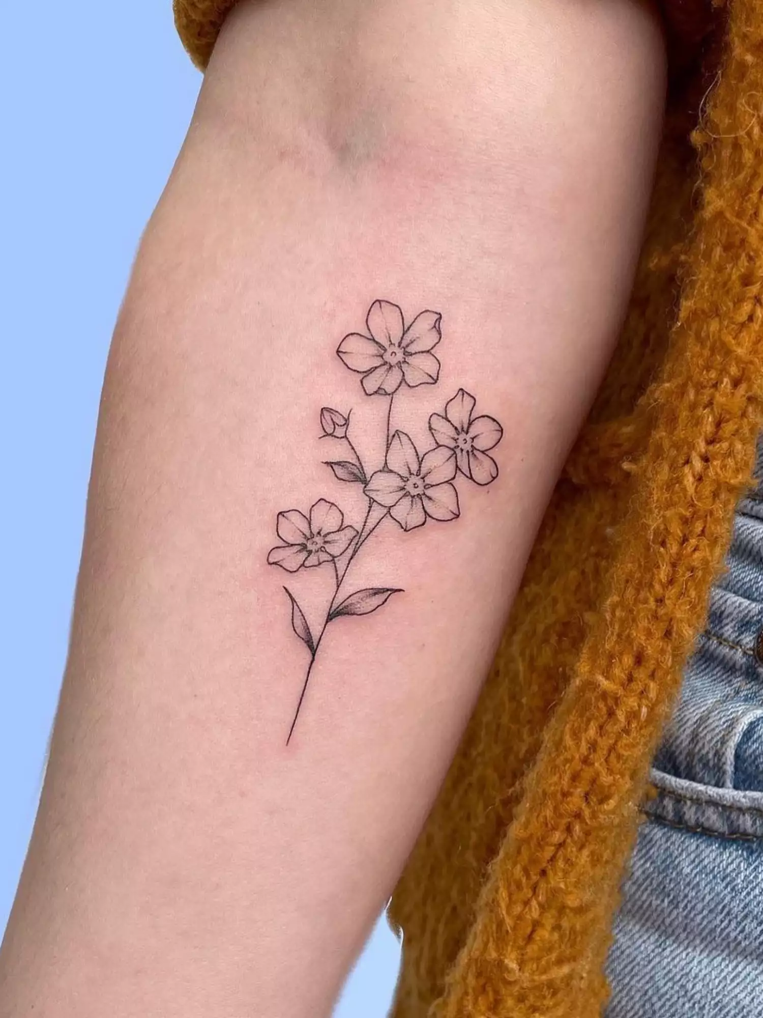 forearm with flower tattoo