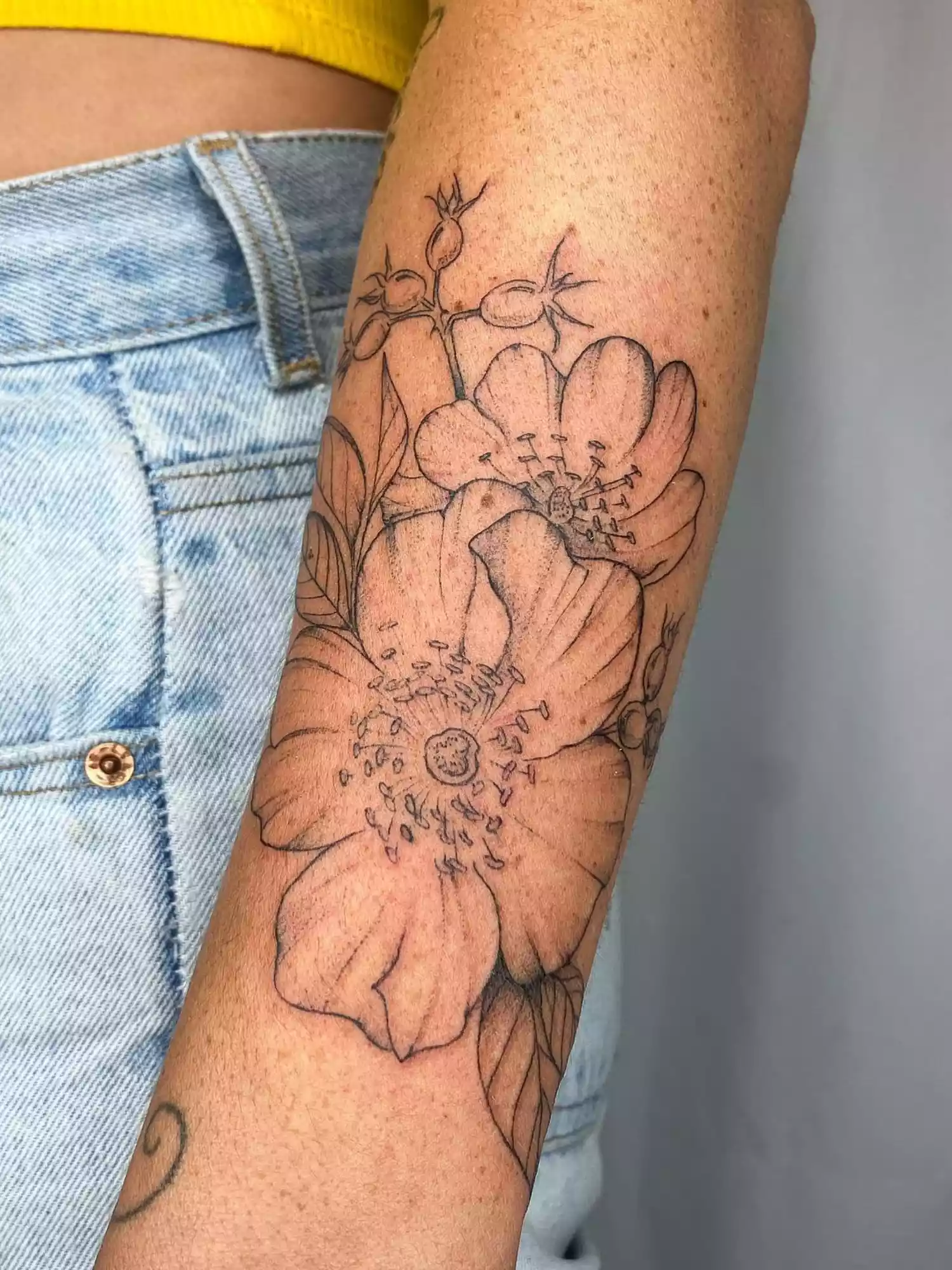 forearm with flower tattoo