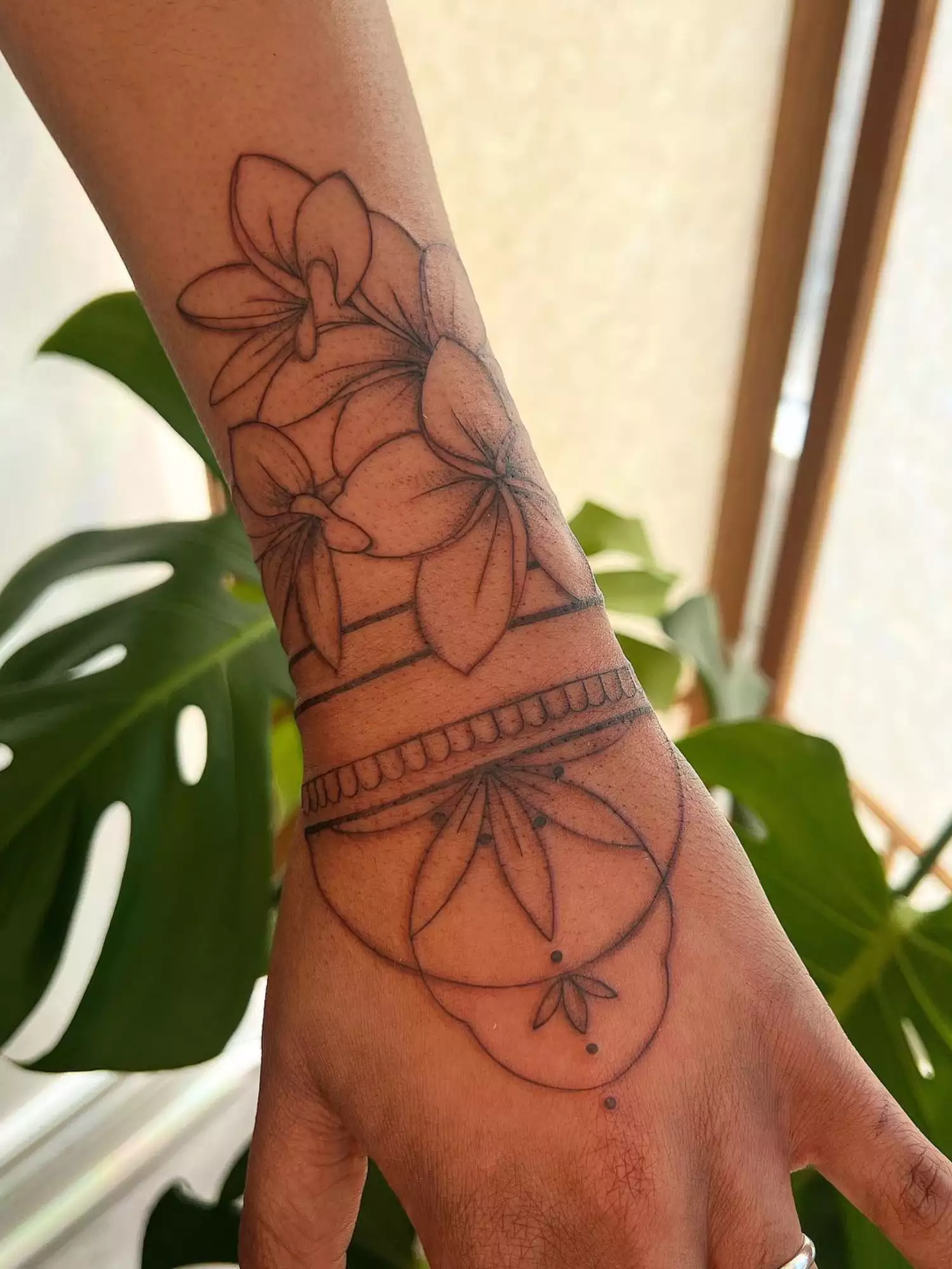 forearm with flower tattoo