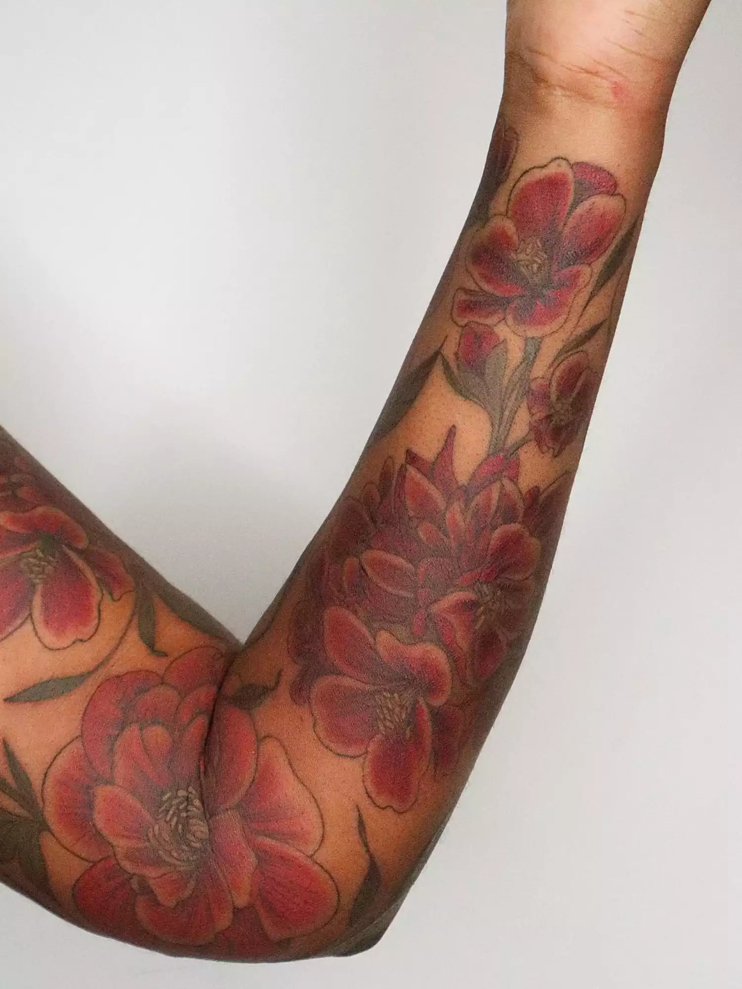 forearm with flower tattoo