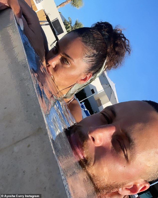 Chilling in the pool: The husband wife team smiled as they bobbed around in the water