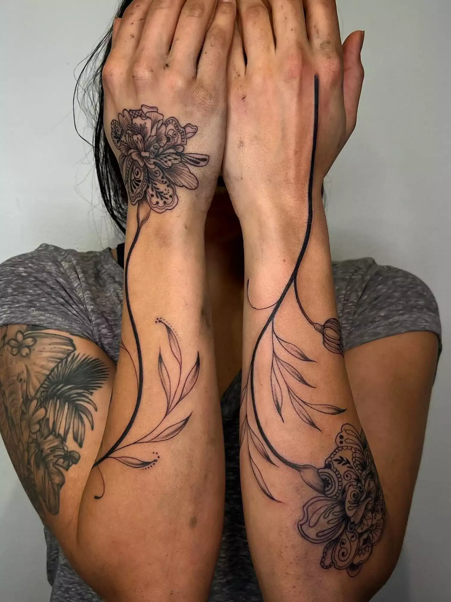 forearm with flower tattoo