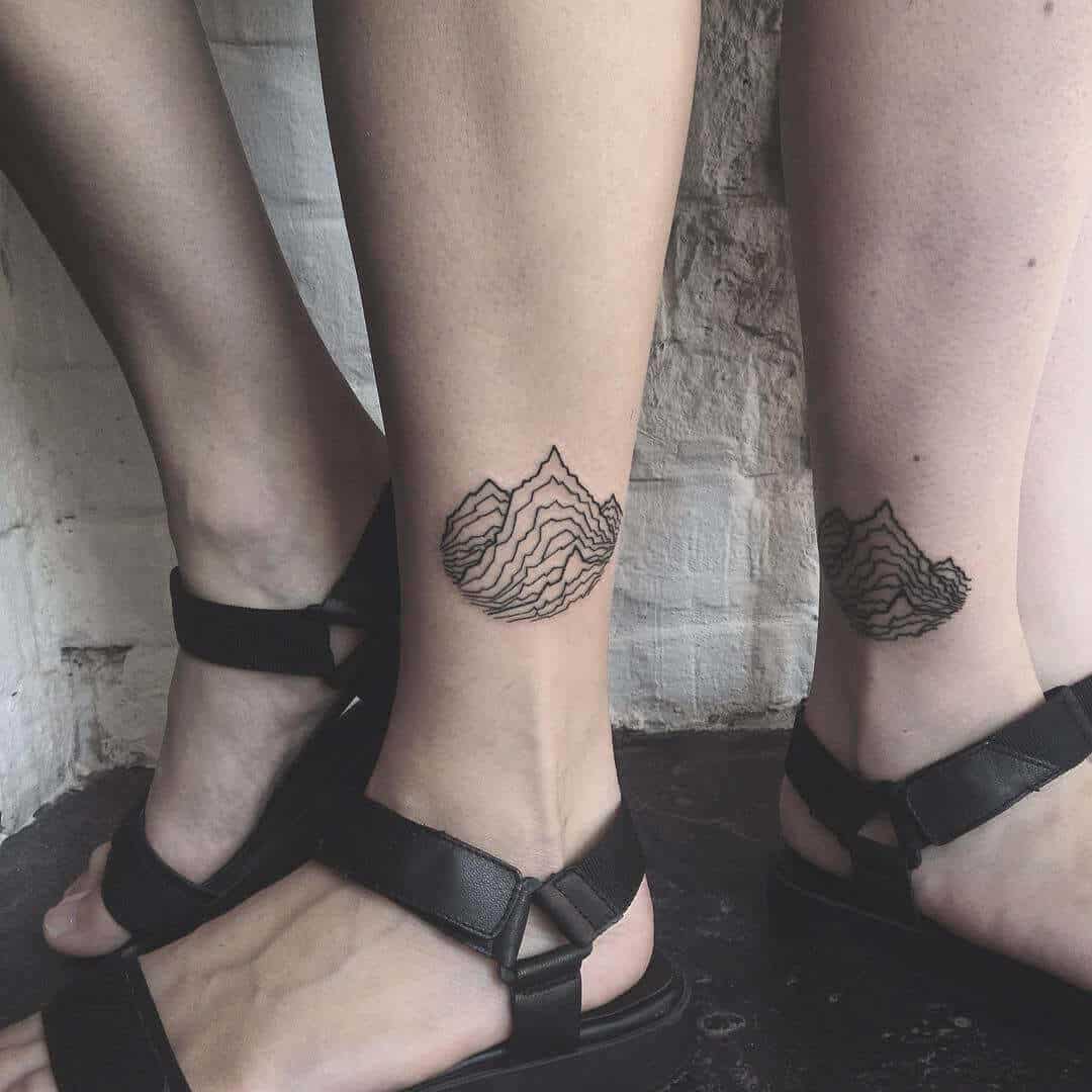 mountain tattoo on leg