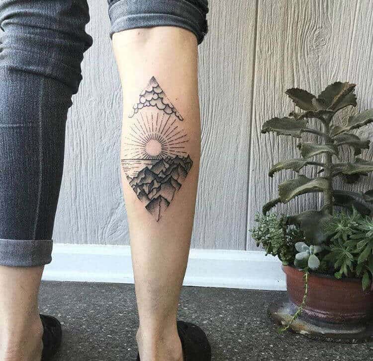 mountain tattoo on leg