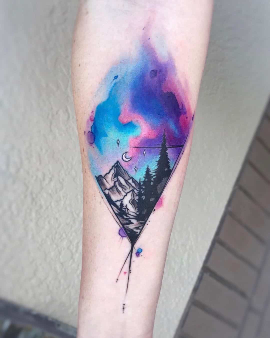 watercolor mountain tattoo on arm