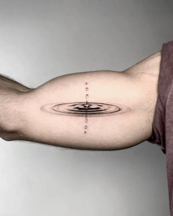 A drop of water bicep tattoo by @kerem.g.tat