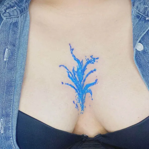 Blue water between the boobs tattoo by @yoni__tattoo