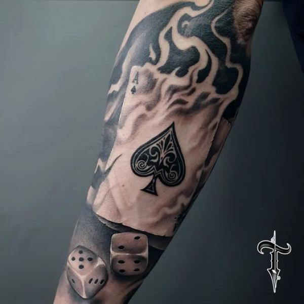 Burning ace of spade playing card with dice tattoo